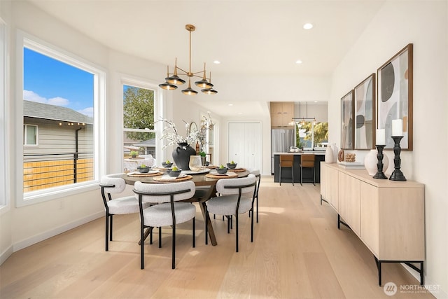 dining room featuring recessed lighting, baseboards, and light wood-type flooring