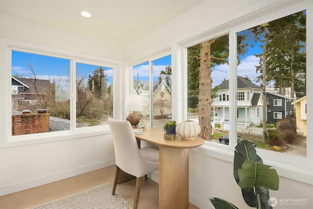 sunroom / solarium featuring a residential view