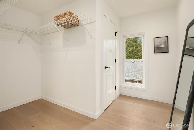 spacious closet with light wood-style floors