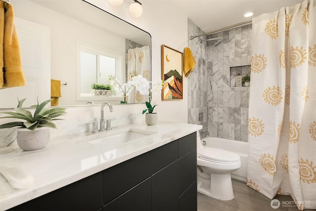 bathroom with vanity, toilet, and shower / bath combo with shower curtain