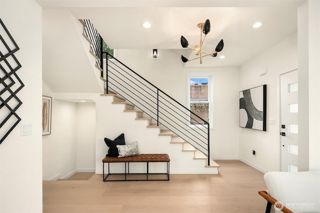 entrance foyer with recessed lighting, stairway, baseboards, and wood finished floors