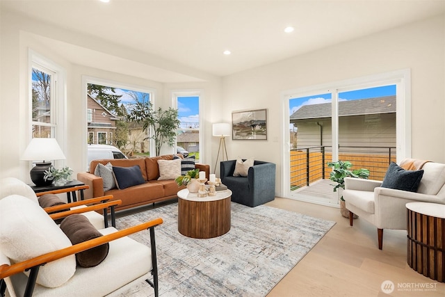 living area featuring recessed lighting, light wood-style floors, and a healthy amount of sunlight