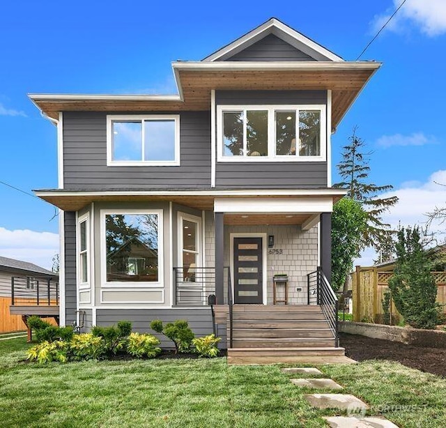 contemporary home with a porch and a front lawn