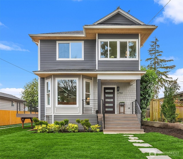 modern home featuring covered porch and a front yard