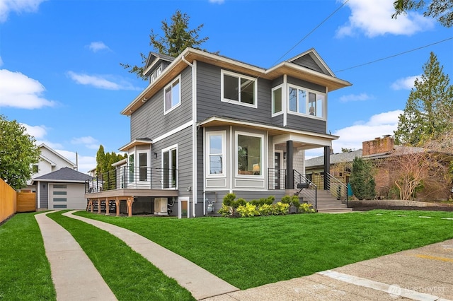 view of front of property featuring an outbuilding, a front lawn, and fence