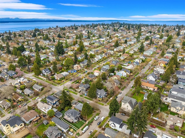 birds eye view of property with a water view and a residential view