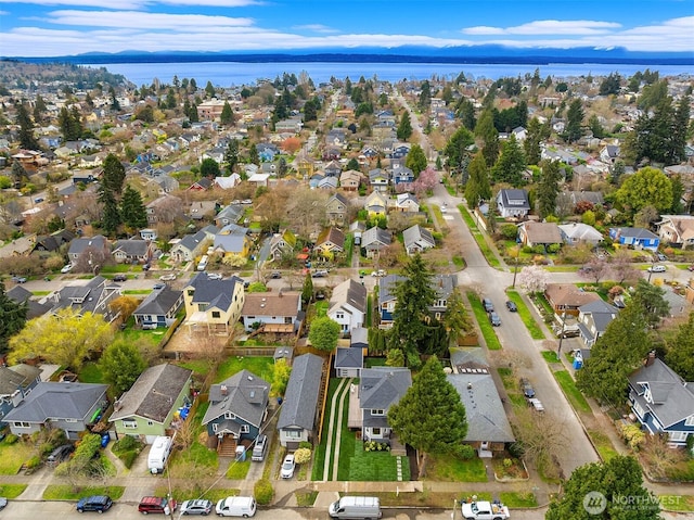 birds eye view of property with a residential view and a water view