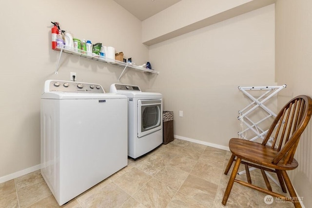 laundry area featuring laundry area, washing machine and dryer, and baseboards