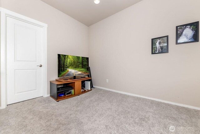 interior space with lofted ceiling and baseboards