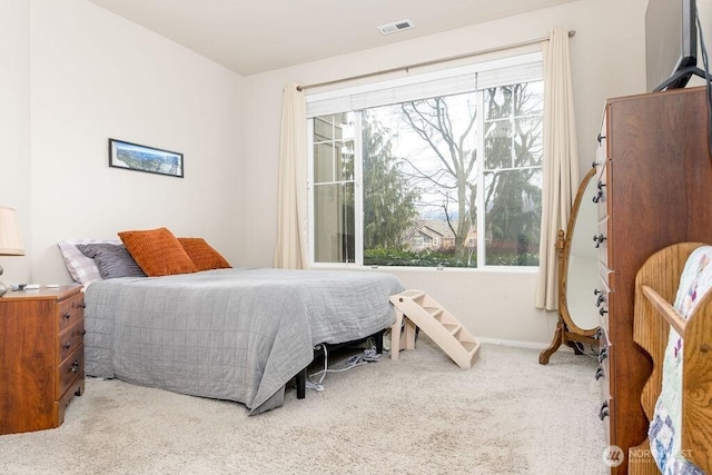 bedroom featuring carpet flooring, multiple windows, baseboards, and visible vents