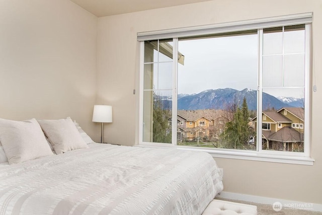 bedroom with a mountain view and baseboards