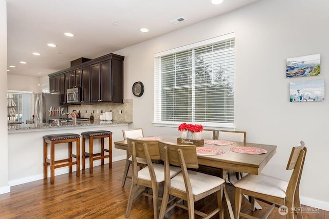 dining space with visible vents, recessed lighting, baseboards, and wood finished floors