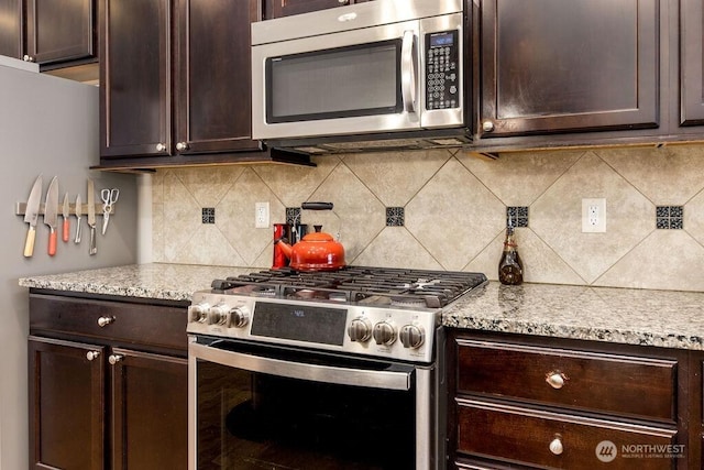 kitchen featuring stainless steel appliances and dark brown cabinets