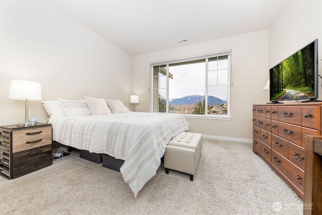 bedroom with visible vents, light colored carpet, and baseboards