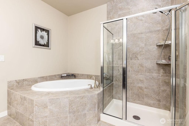 bathroom with a shower stall and a garden tub