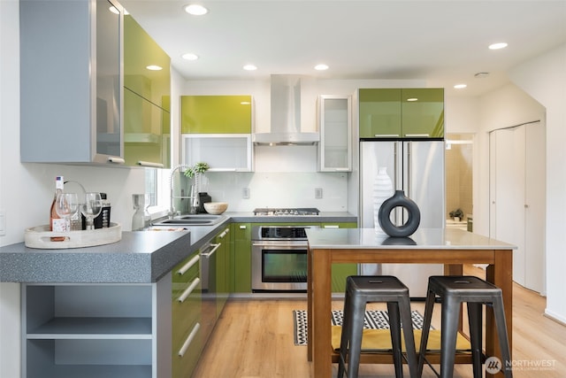 kitchen featuring a kitchen bar, open shelves, a sink, stainless steel appliances, and extractor fan