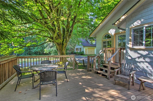 wooden deck featuring outdoor dining area