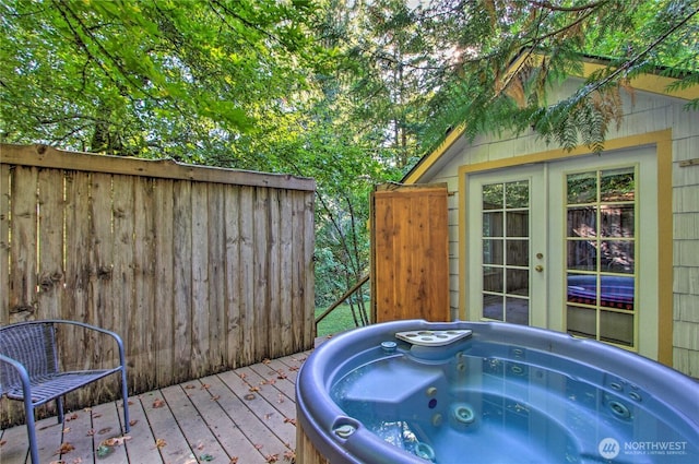 wooden terrace featuring french doors and a hot tub