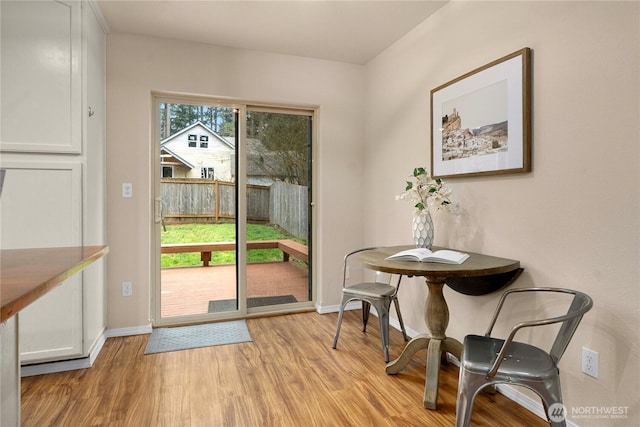 entryway with light wood-type flooring and baseboards