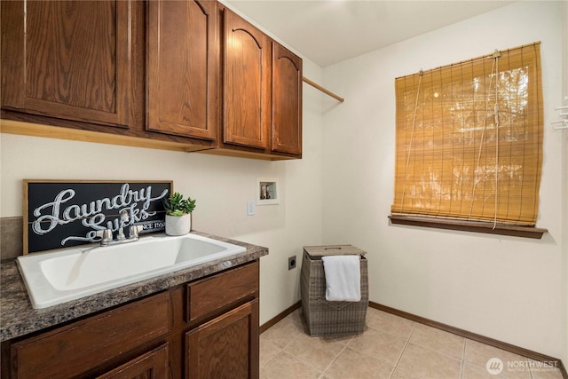 laundry area with light tile patterned flooring, cabinet space, electric dryer hookup, washer hookup, and a sink