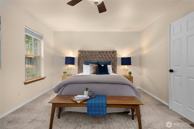 bedroom with ceiling fan, baseboards, and carpet