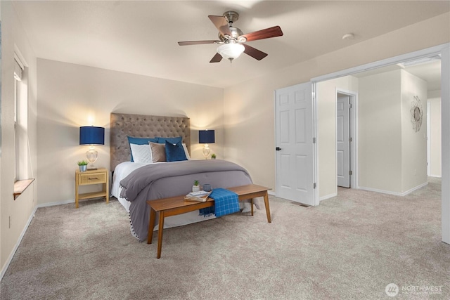 carpeted bedroom with ceiling fan and baseboards