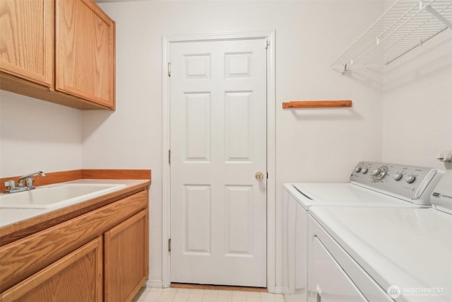 laundry room featuring a sink, cabinet space, and washing machine and dryer