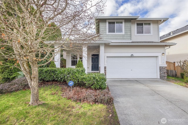 traditional-style home featuring concrete driveway, an attached garage, and fence