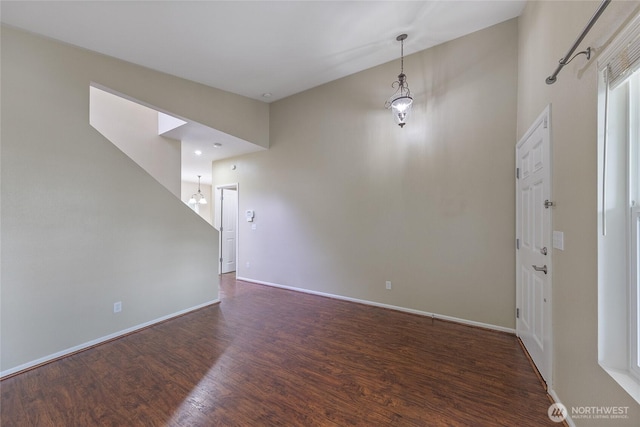 interior space featuring baseboards and wood finished floors