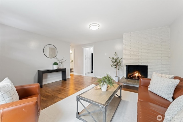 living room featuring wood finished floors and a fireplace