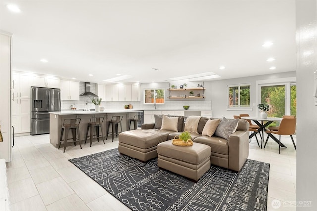 living area featuring recessed lighting, a healthy amount of sunlight, and light tile patterned floors