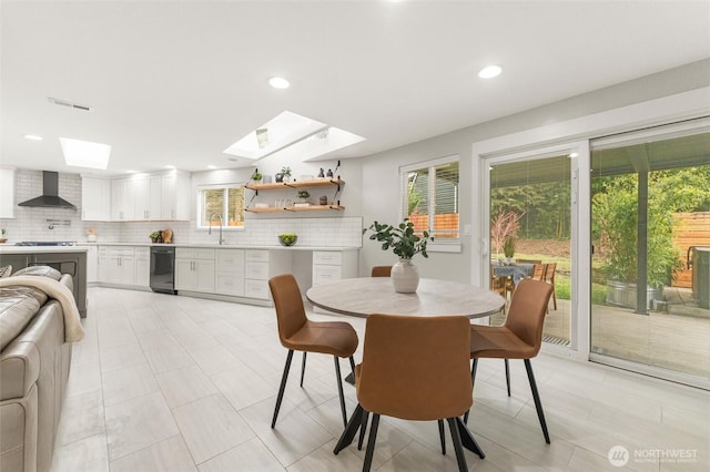 dining space with recessed lighting, visible vents, and a skylight