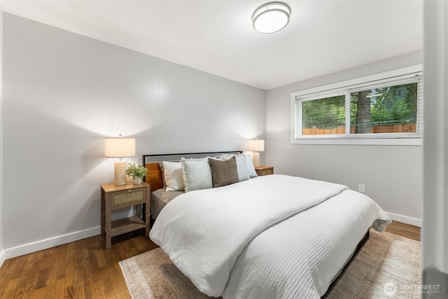 bedroom featuring baseboards and wood finished floors