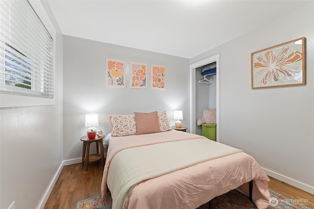 bedroom featuring baseboards and wood finished floors