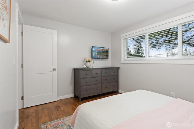 bedroom with baseboards and wood finished floors