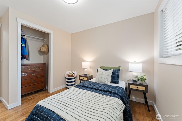 bedroom featuring baseboards and wood finished floors