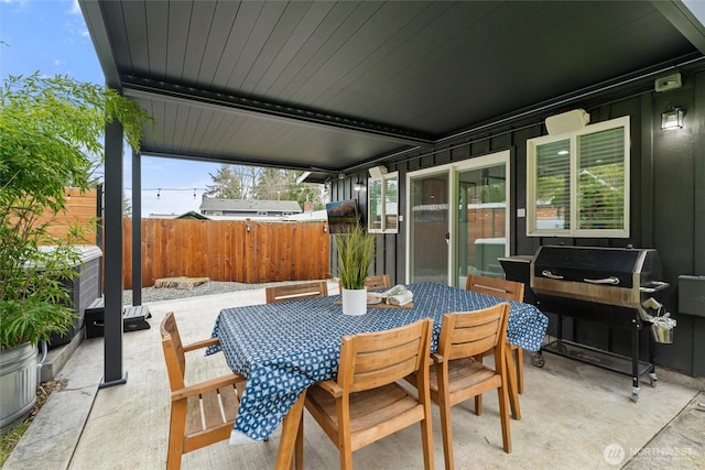 view of patio with outdoor dining space, a grill, and fence