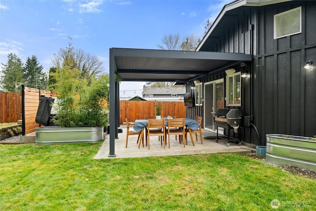 exterior space featuring grilling area, a vegetable garden, and fence