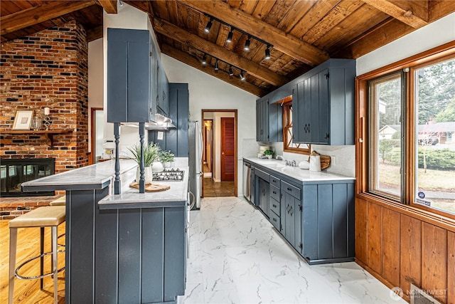 kitchen with wood ceiling, stainless steel appliances, marble finish floor, and a peninsula