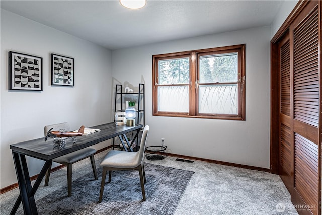 office space with carpet, visible vents, and baseboards