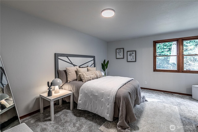 carpeted bedroom with visible vents and baseboards