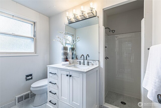 bathroom featuring toilet, a healthy amount of sunlight, visible vents, and a stall shower