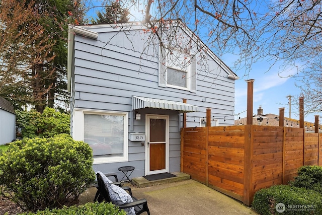 exterior space featuring entry steps and fence