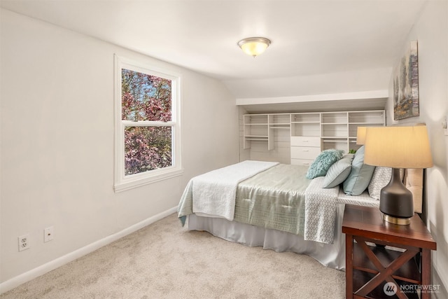 bedroom with baseboards, carpet, and vaulted ceiling