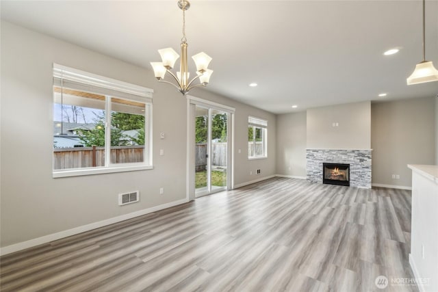 unfurnished living room featuring light wood-type flooring, visible vents, baseboards, and recessed lighting