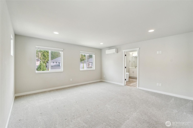 carpeted empty room featuring recessed lighting, baseboards, and a wall unit AC