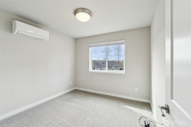 carpeted spare room featuring a wall mounted air conditioner and baseboards