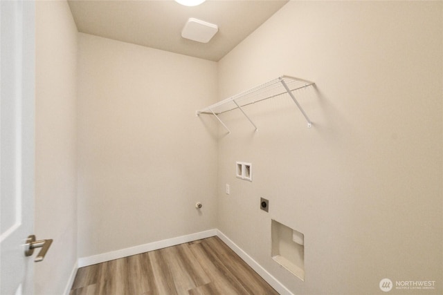 laundry room with laundry area, wood finished floors, baseboards, and washer hookup