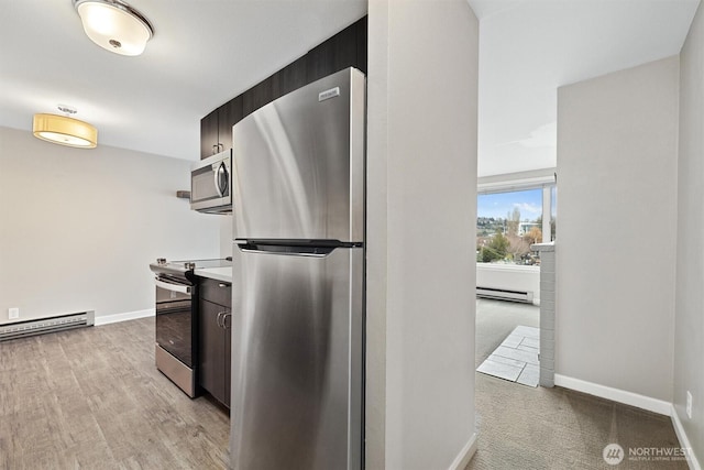 kitchen featuring stainless steel appliances, baseboards, baseboard heating, and a baseboard heating unit