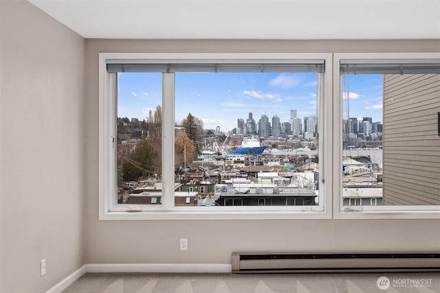 details with a city view, a baseboard radiator, baseboards, and carpet floors